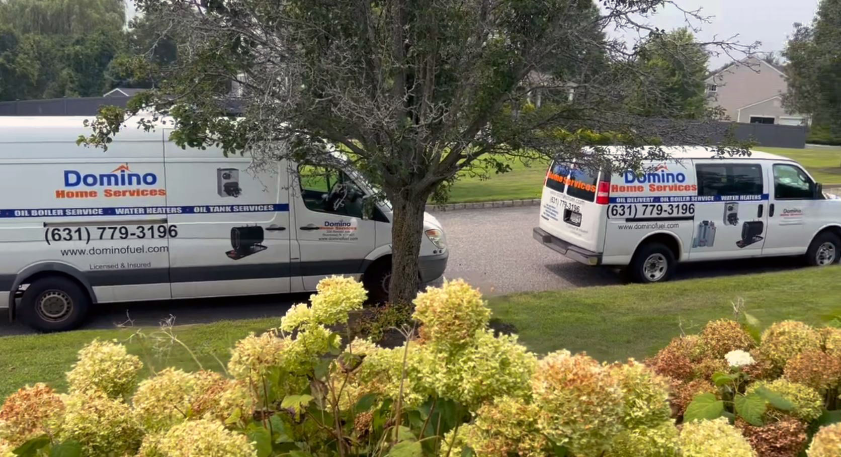 Domino Home Services water heater service vans on Long Island
